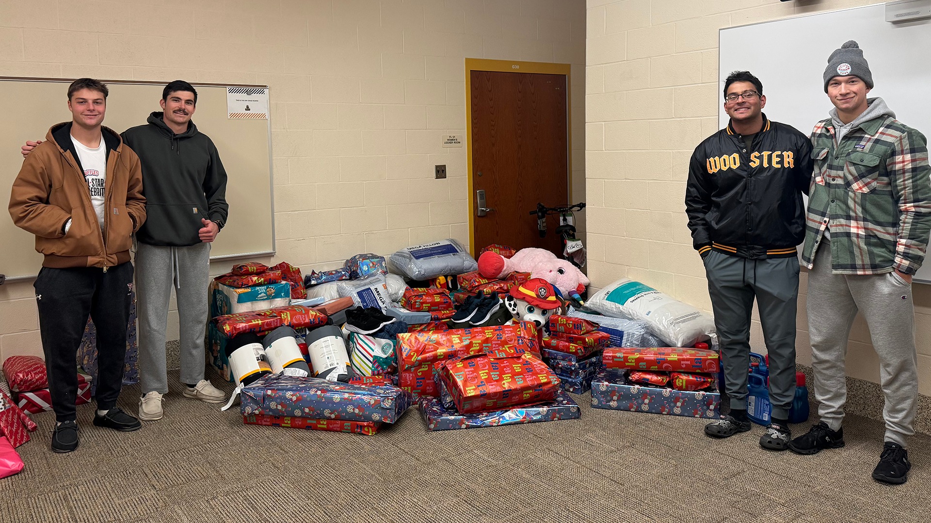 Wooster student-athletes with presents as part of their 2025 holiday service project