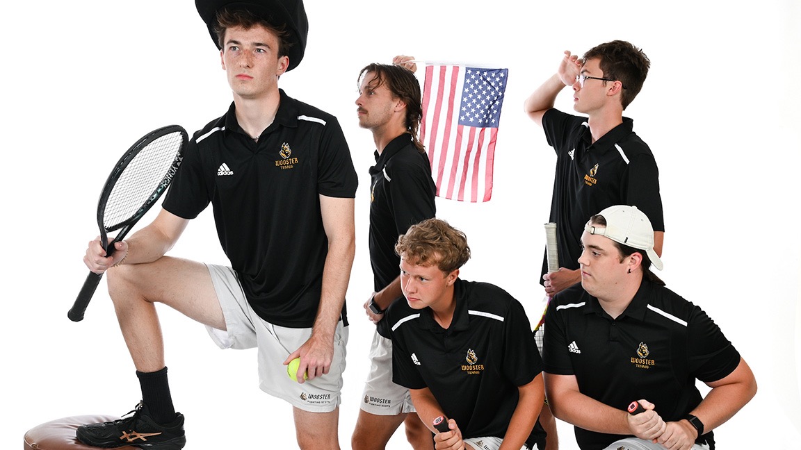 Five players pose during photo day, recreating an image of rowing a boat