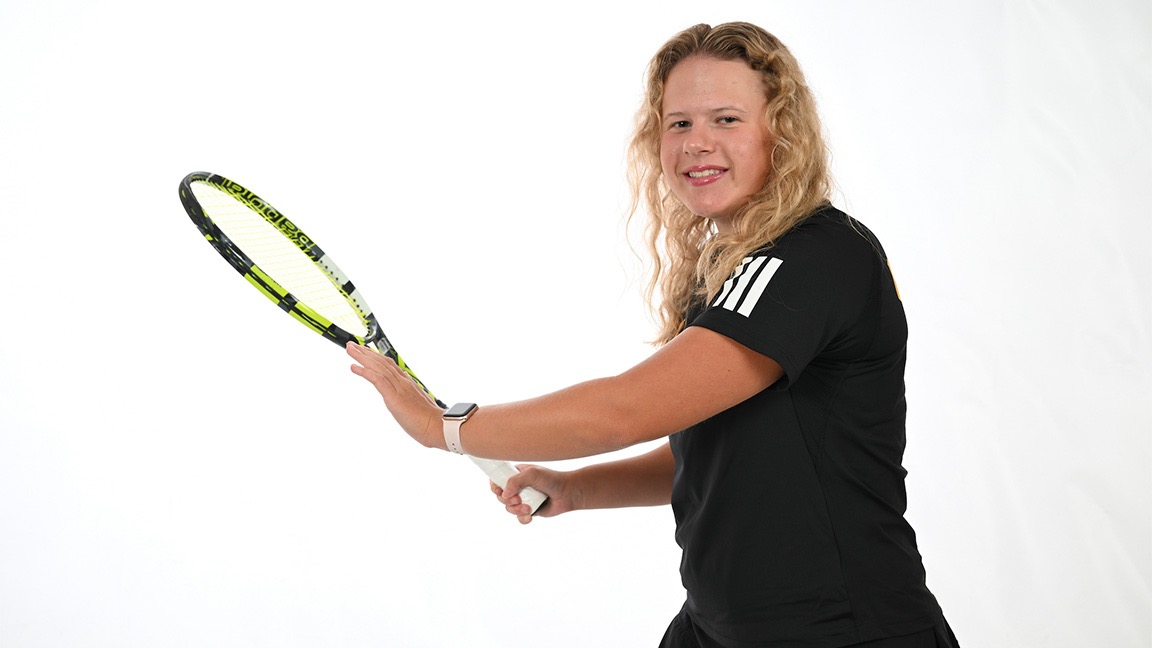 Meiners poses with a tennis racquet