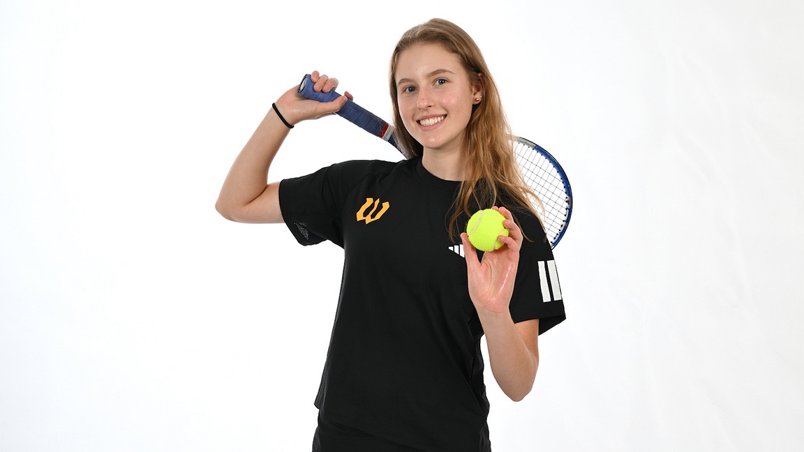 Sasha Riley poses with tennis racquet and ball