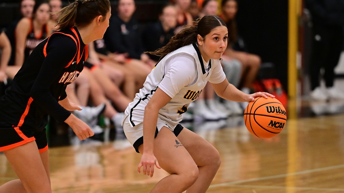 Mya Rivera dribbles with a defender in front of her