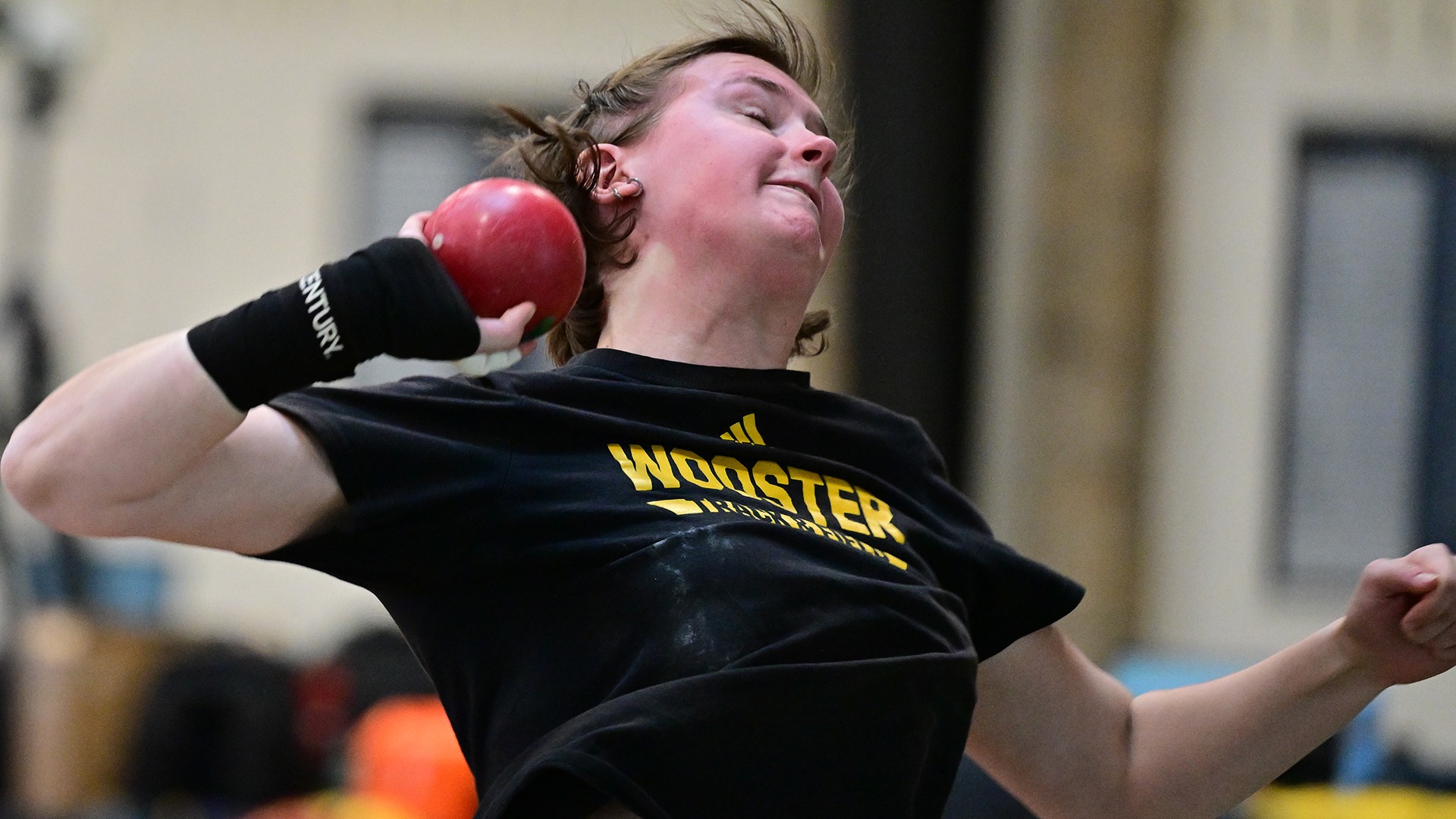 Evie Sanford throws the shot put in a 2026 home meet