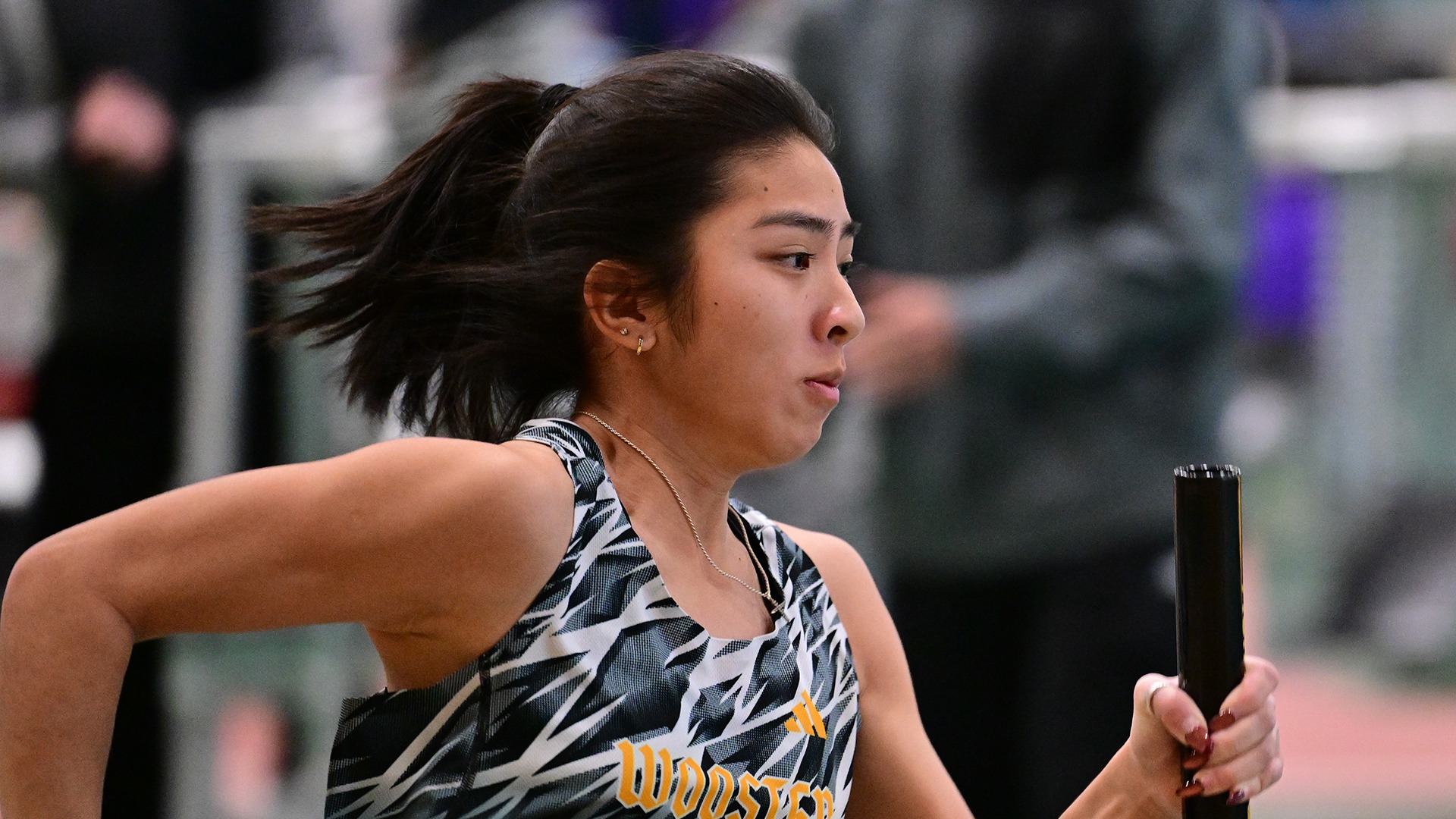 Emeili Tarpy runs a relay leg during a 2026 meet