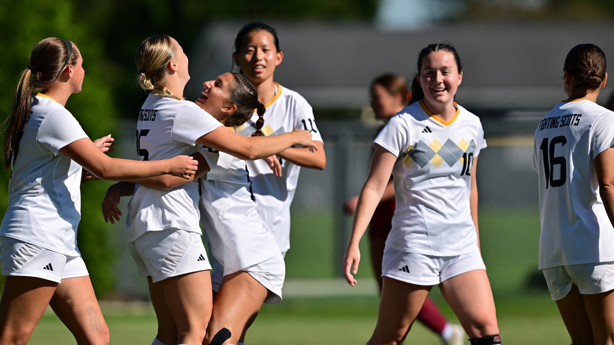 The women's soccer team celebrates following a goal