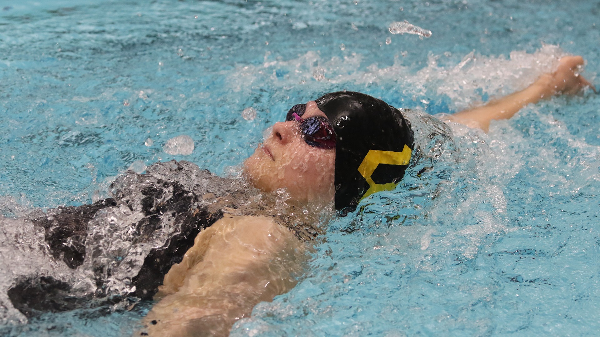 action photo of Anna Lundquist swimming the backstroke at the 2026 NCAC Championships