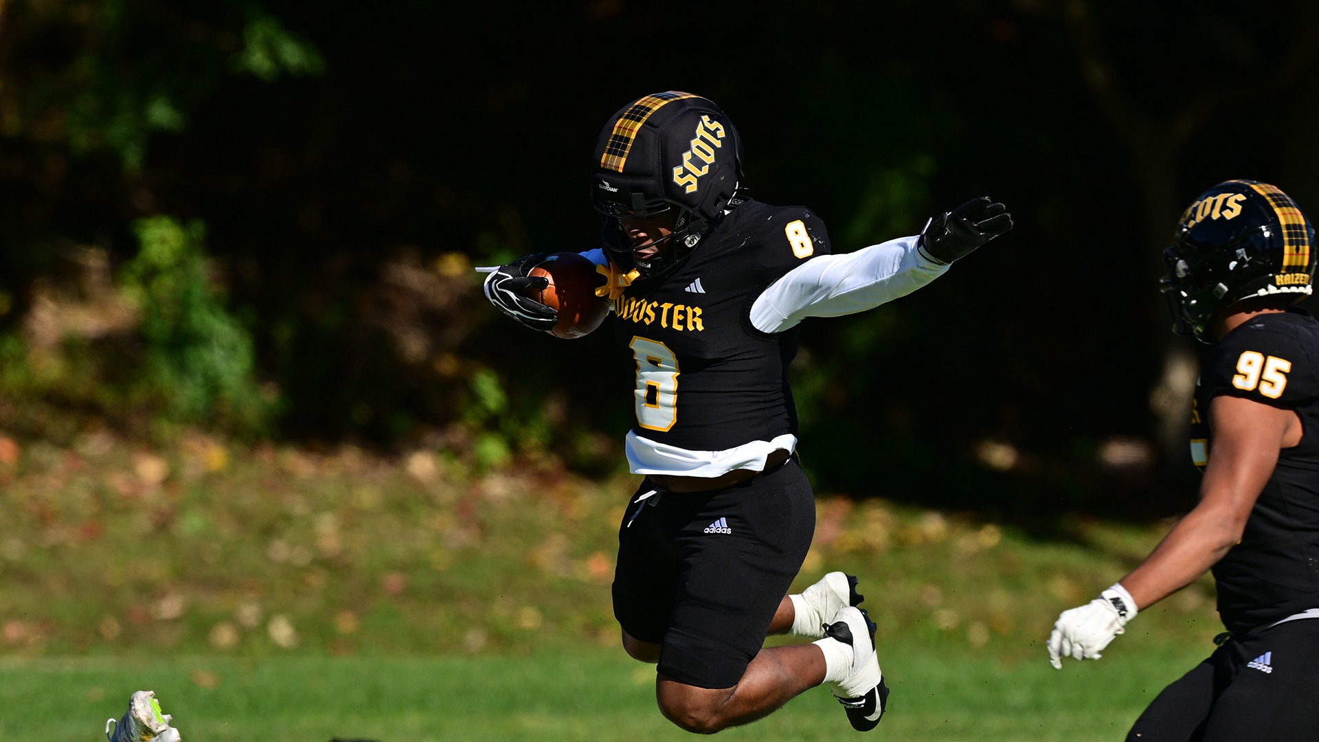 Action photo of Marky Flood Fitzgerald returning an interception in a 2026 game against Oberlin