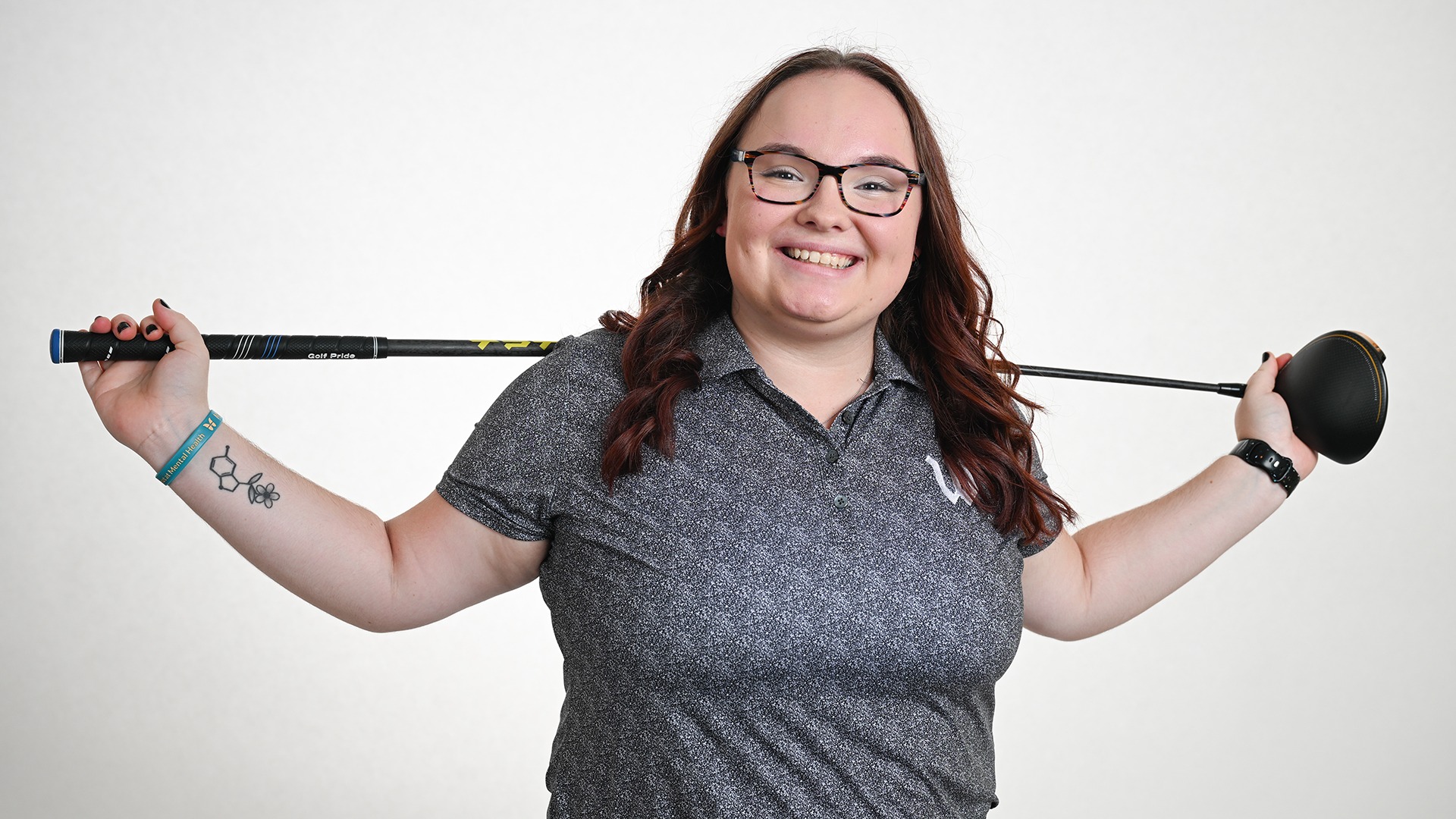 posed shot of Abby Haywood with driver behind her from the 2026-27 women's golf media day