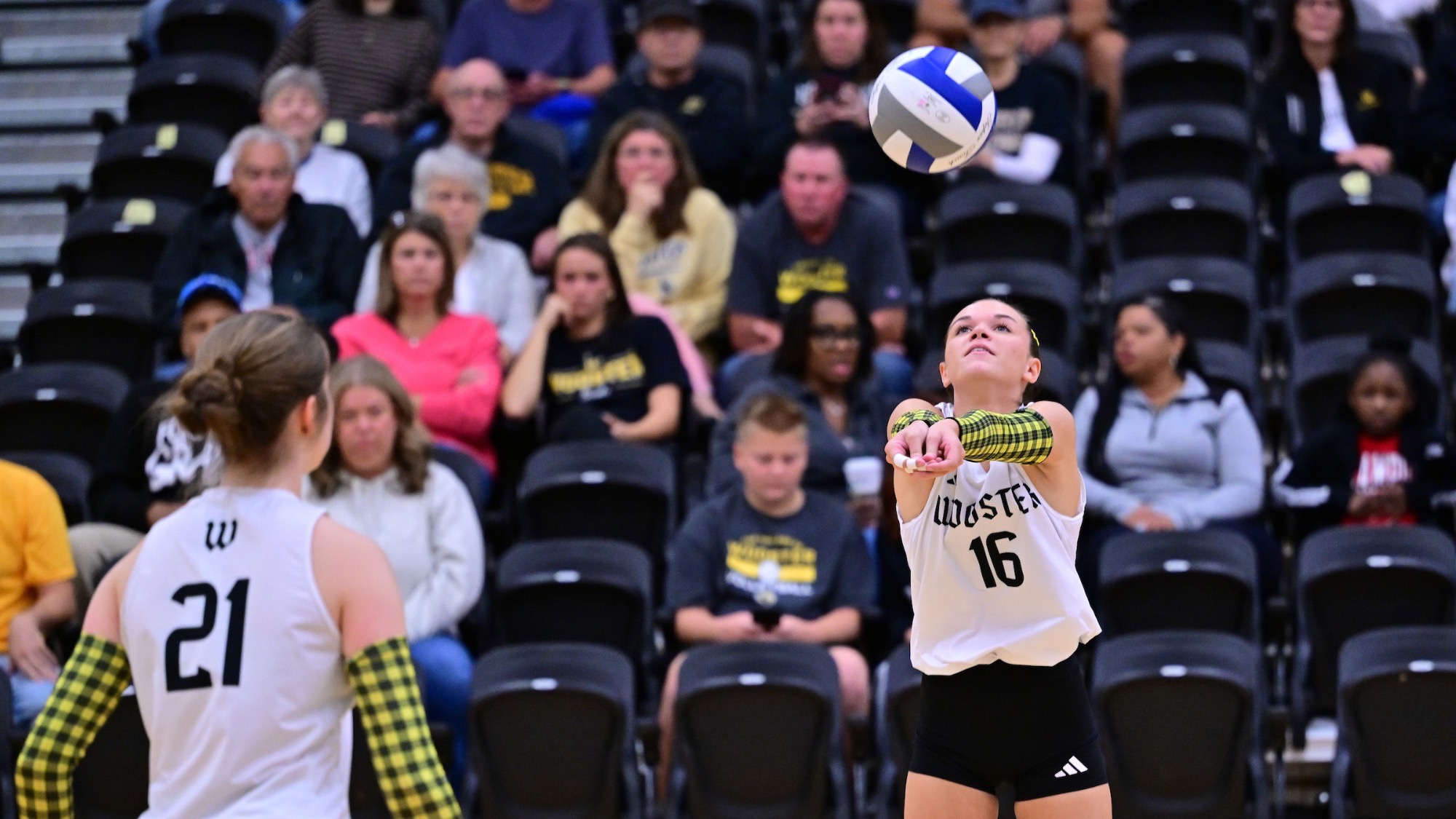 Ireland Oswick sets the ball as Kora Burill looks on facing away from the foreground