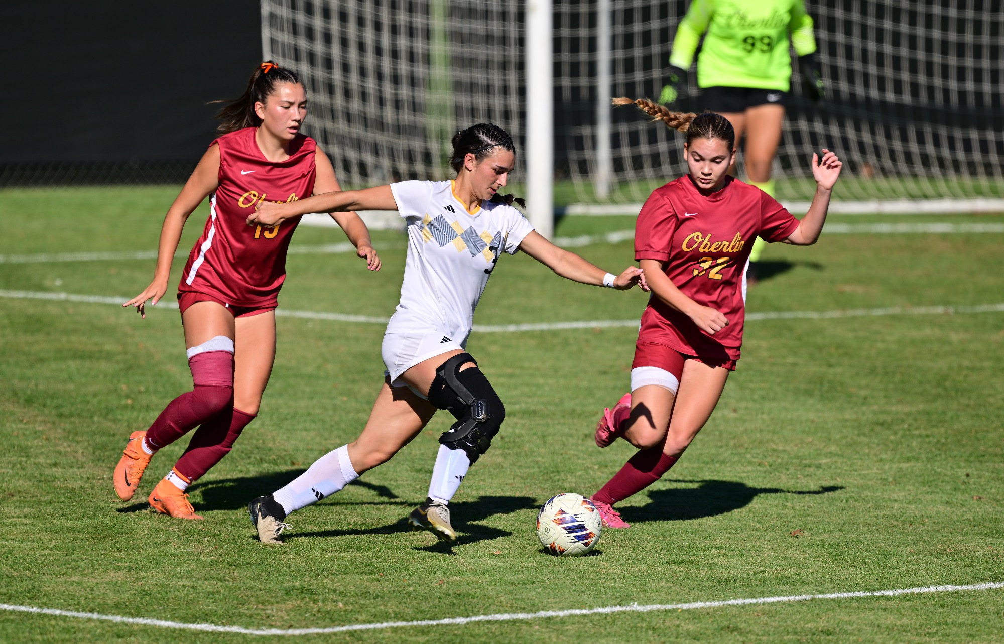 action shot of Josie Bencic competing to maintain possession of the soccer ball during the 2026 soccer match against Oberlin College