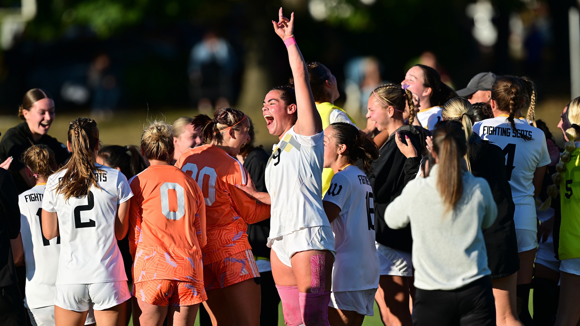 Julia Struck and the women's soccer team celebrate after capturing the NCAC title