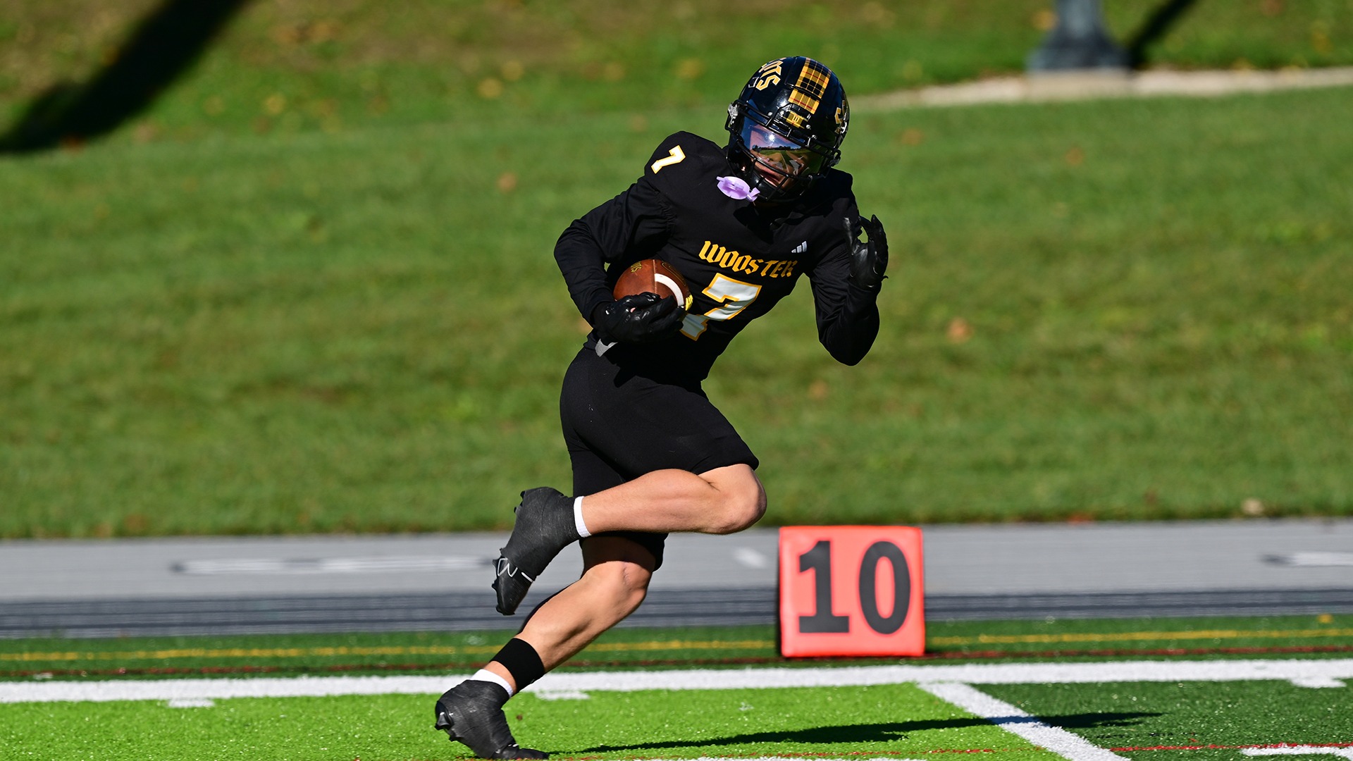 action photo of Logan Hupp going in for a touchdown during a 2026 game against Oberlin