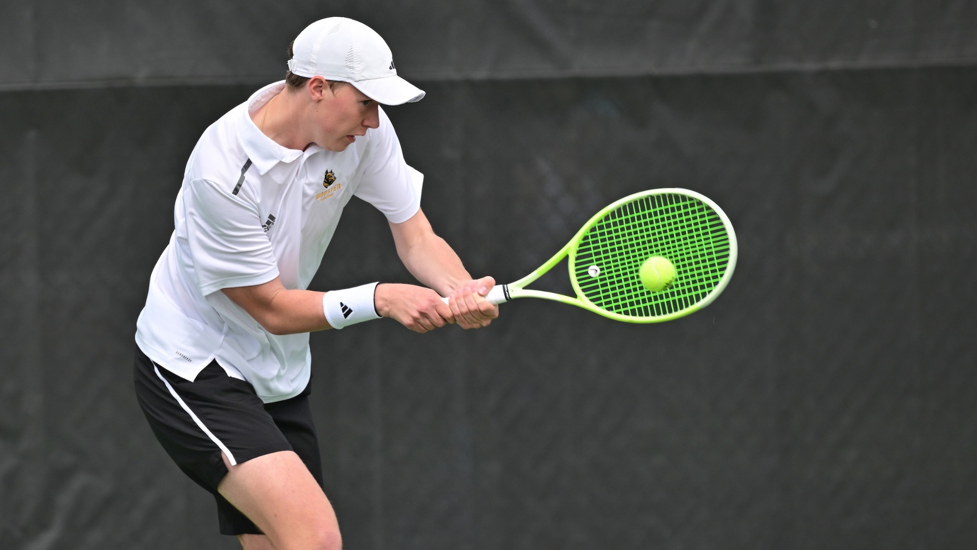 Ian Royse hits a backhand, indoors