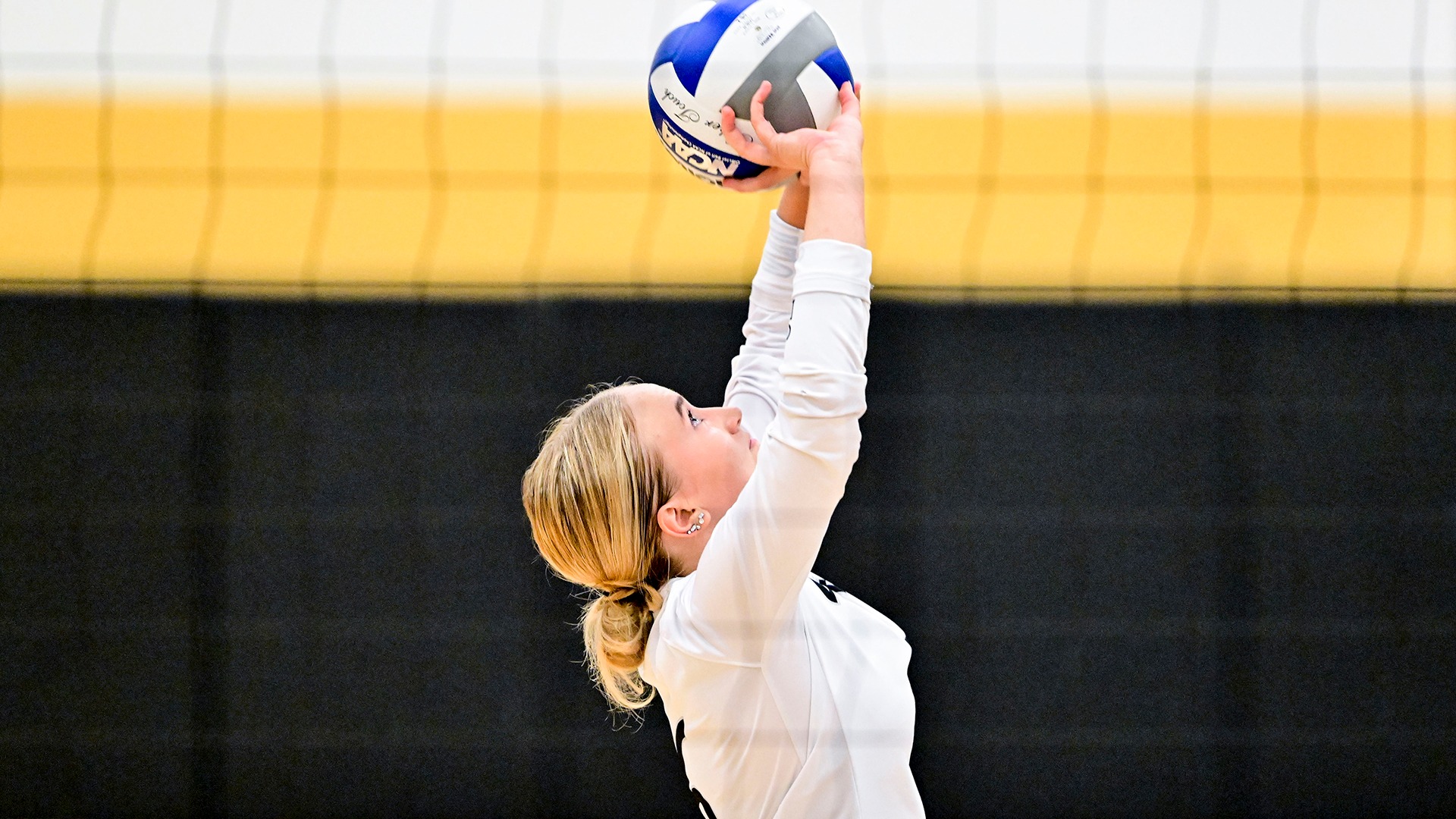 action photo of Emma Fleck setting the volleyball in a 2024 match
