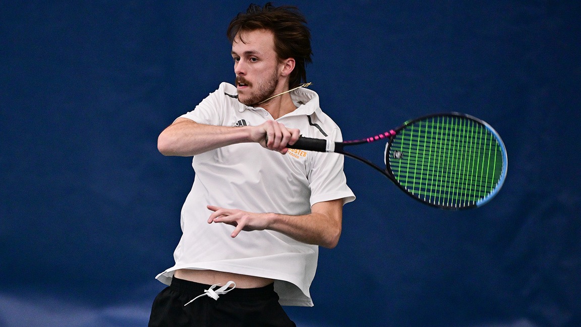Anthony VanOyen swings at a tennis ball indoors