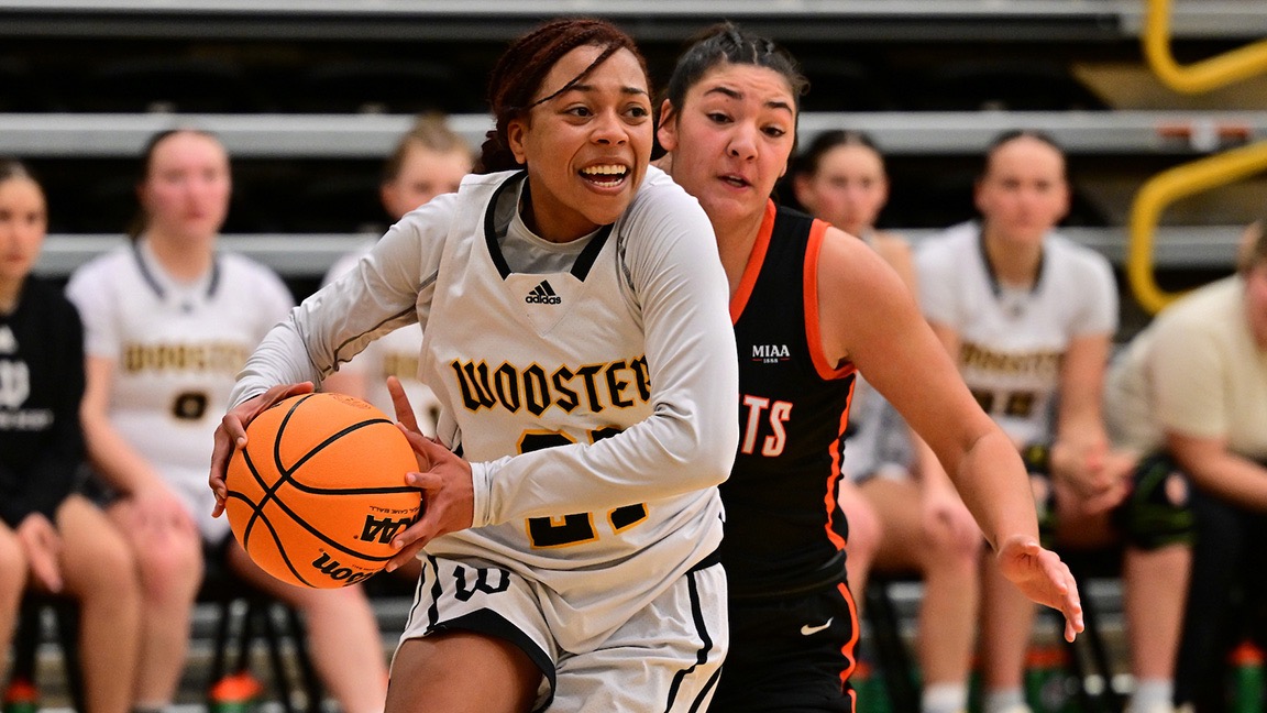 Ace Sturdivant drives toward the basket with the ball past a defender