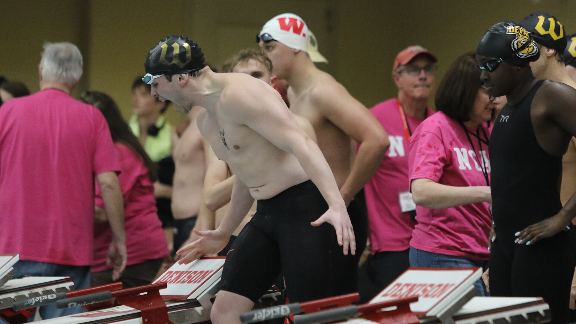 Callum Glover cheers on a teammate during the NCAC Championships