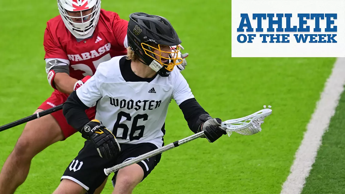 Lane Kellogg holds a lacrosse ball as a defender looks upon from behind