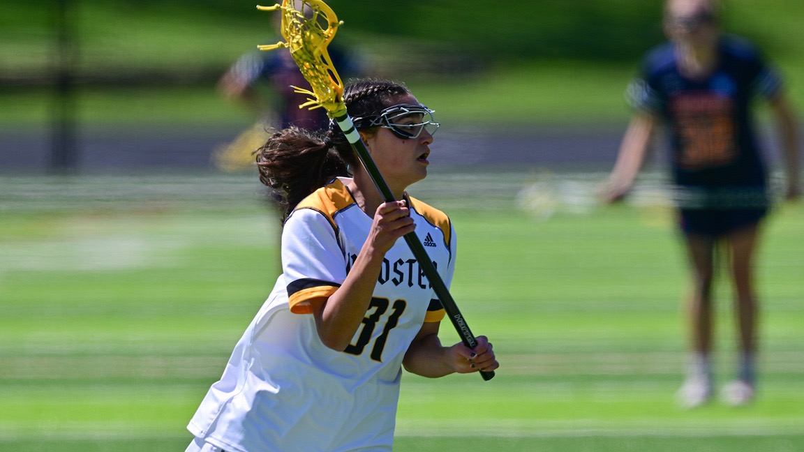 Sophia Mellis with a lacrosse stick and ball in the pouch, looks to make a play