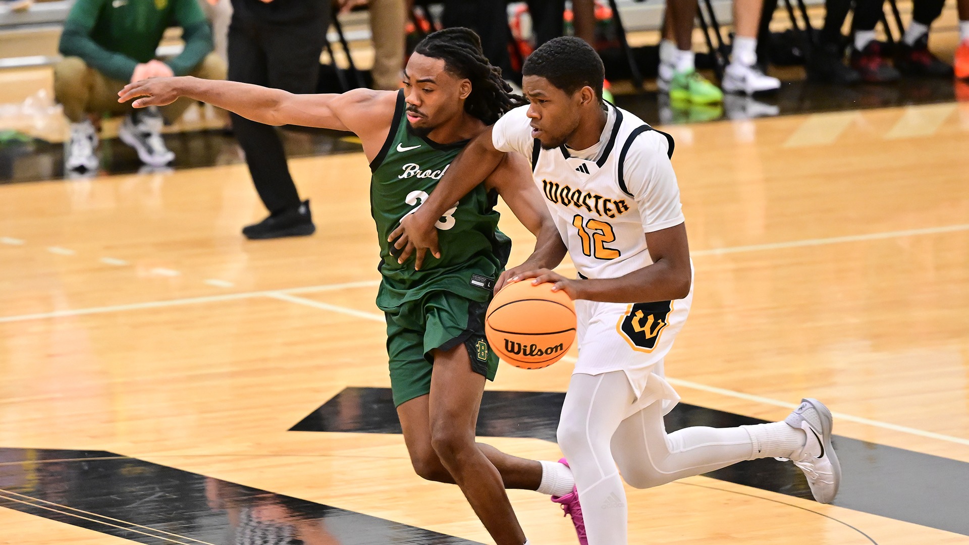 Isaiah Johnson drives towards the basket against Brockport in a 2025 game.