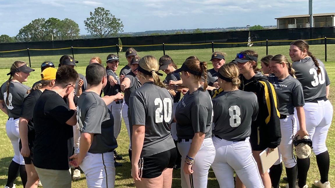 The softball huddles following their win over Salem State on their spring break trip