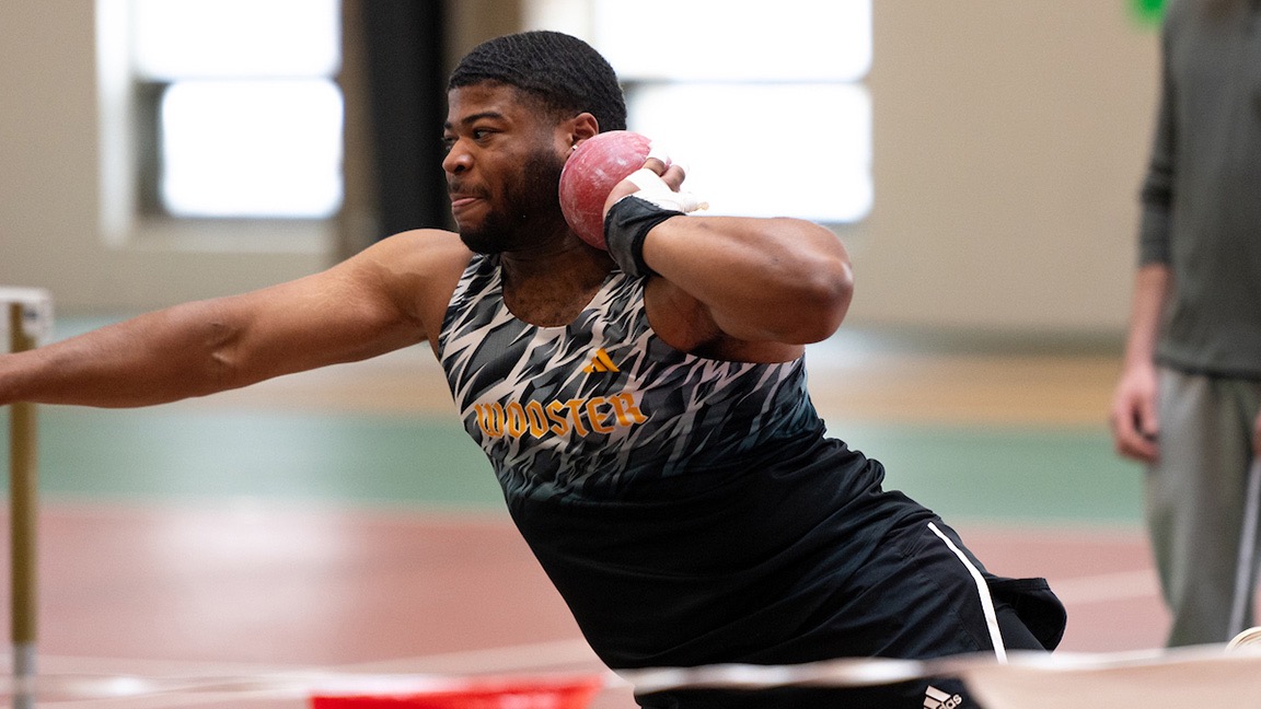 Rob Mays III prepares to throw the shot put indoors