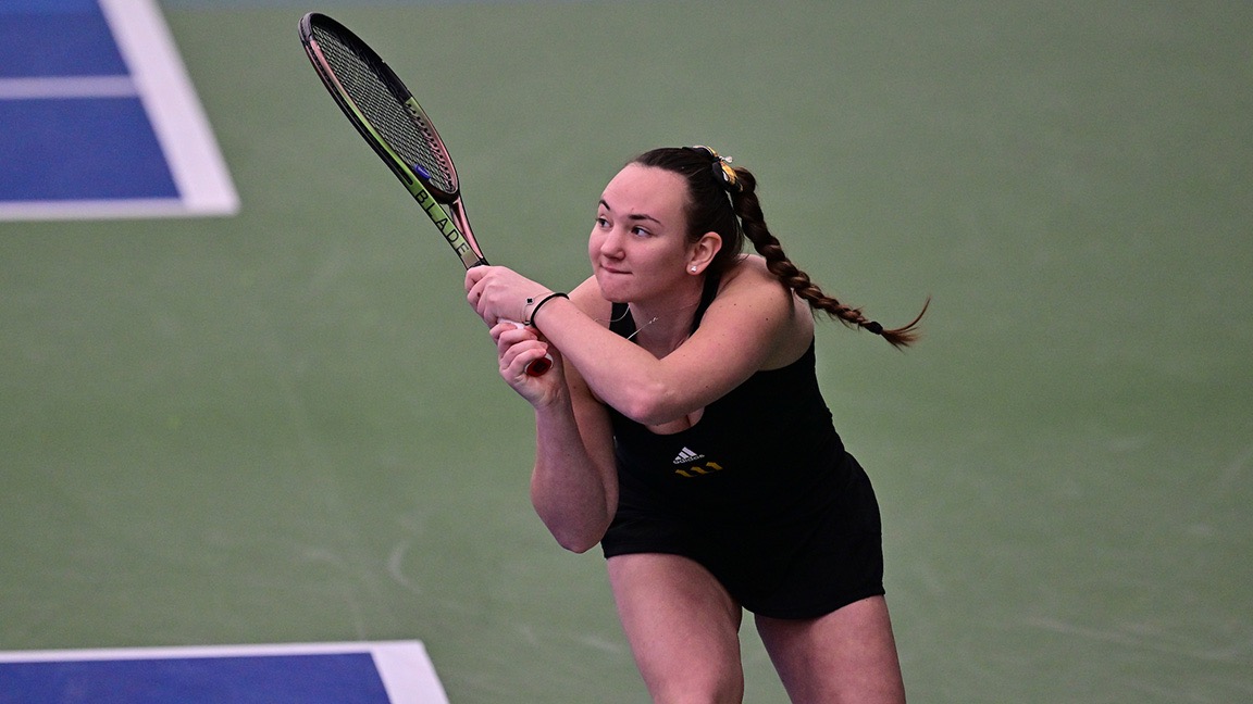 Lauren Richmond follows through with a backhand indoors