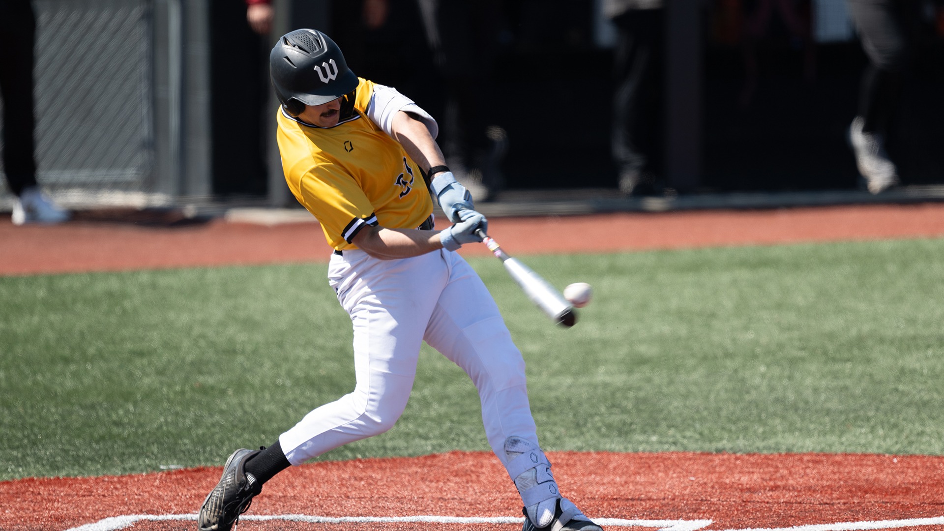Ryan Kramer puts the ball in play during a 2026 game against Oberlin