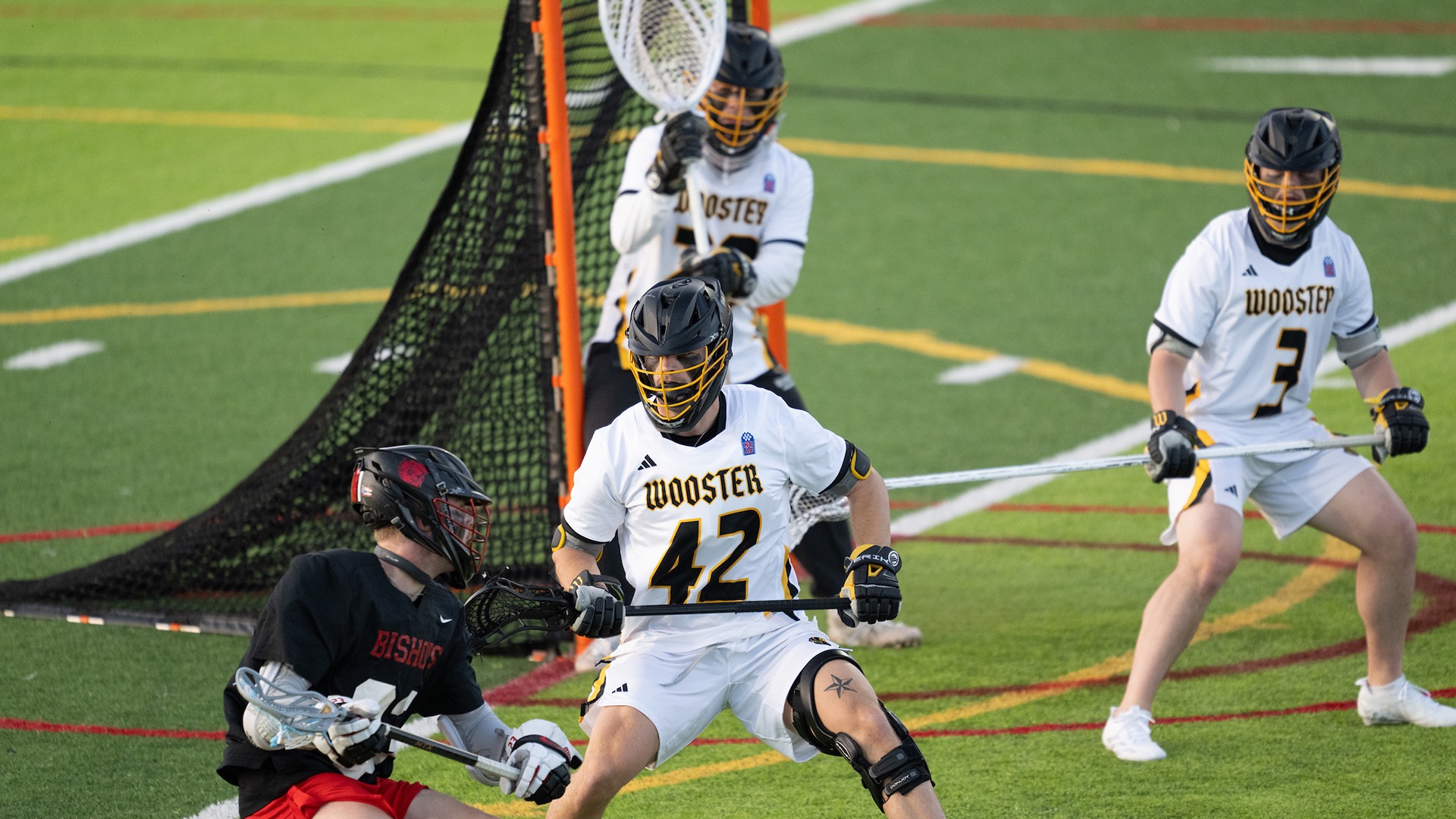 Cooper Nichols plays defense with the keeper behind him and an opponent in front