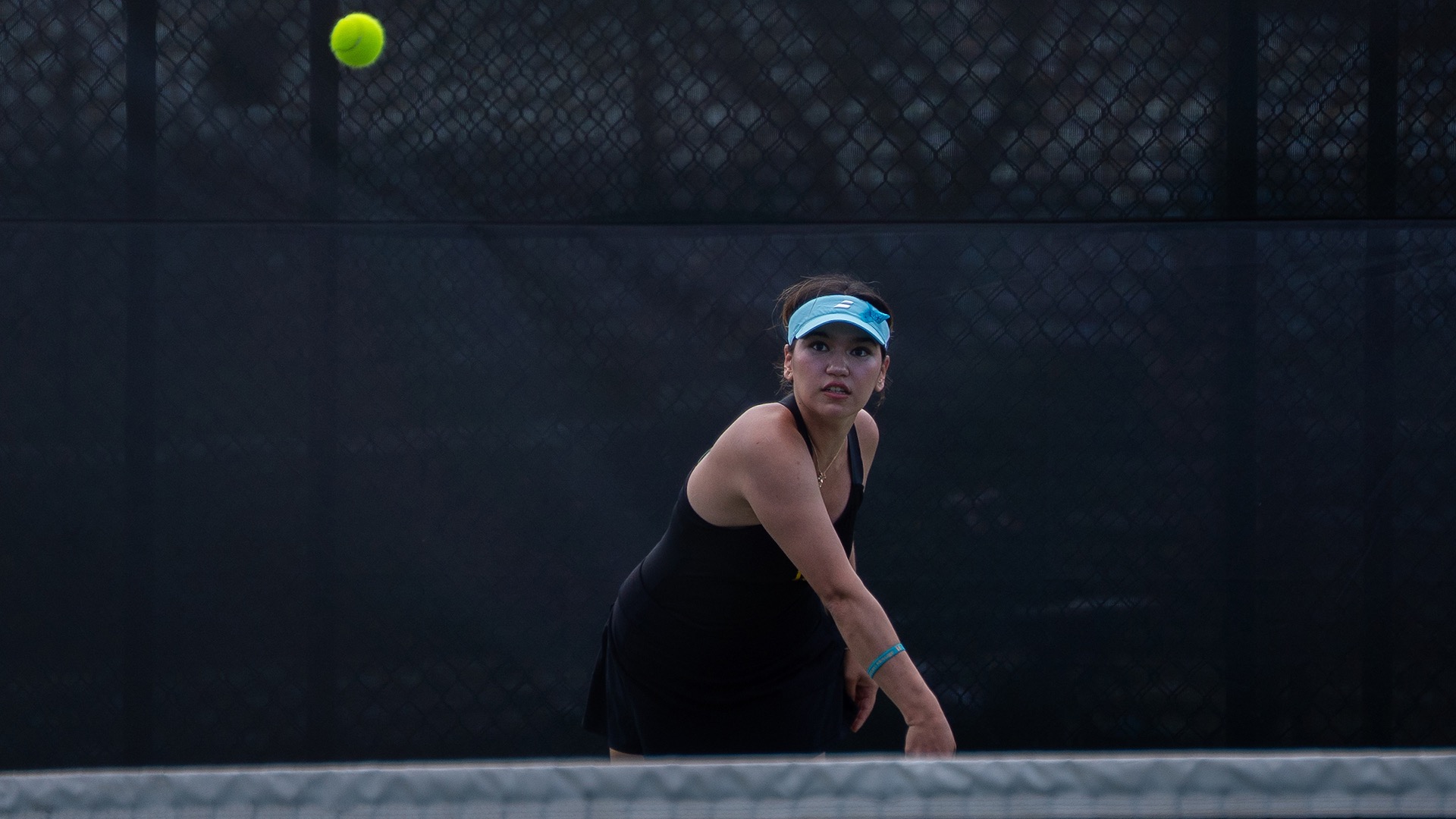 Kamila Kadirova serves on the follow through and the ball heading over the net