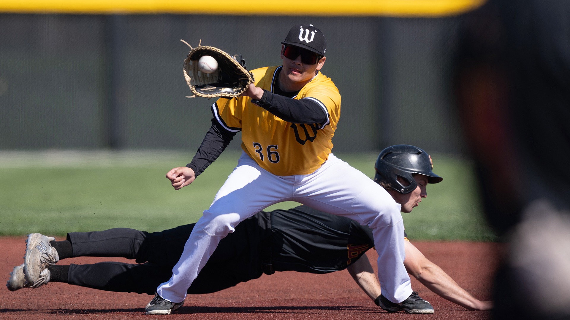 Koa Siu catches a throw at first base in a 2026 game