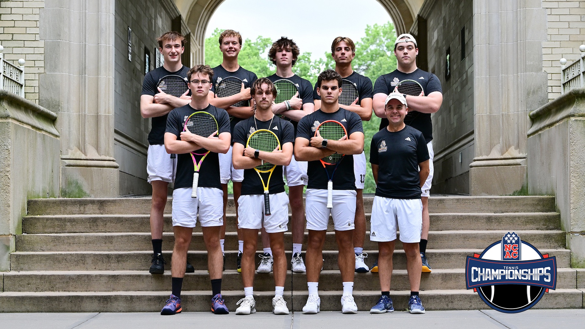 The 2025-26 men's tennis team photo with eight players and one coach across two rows