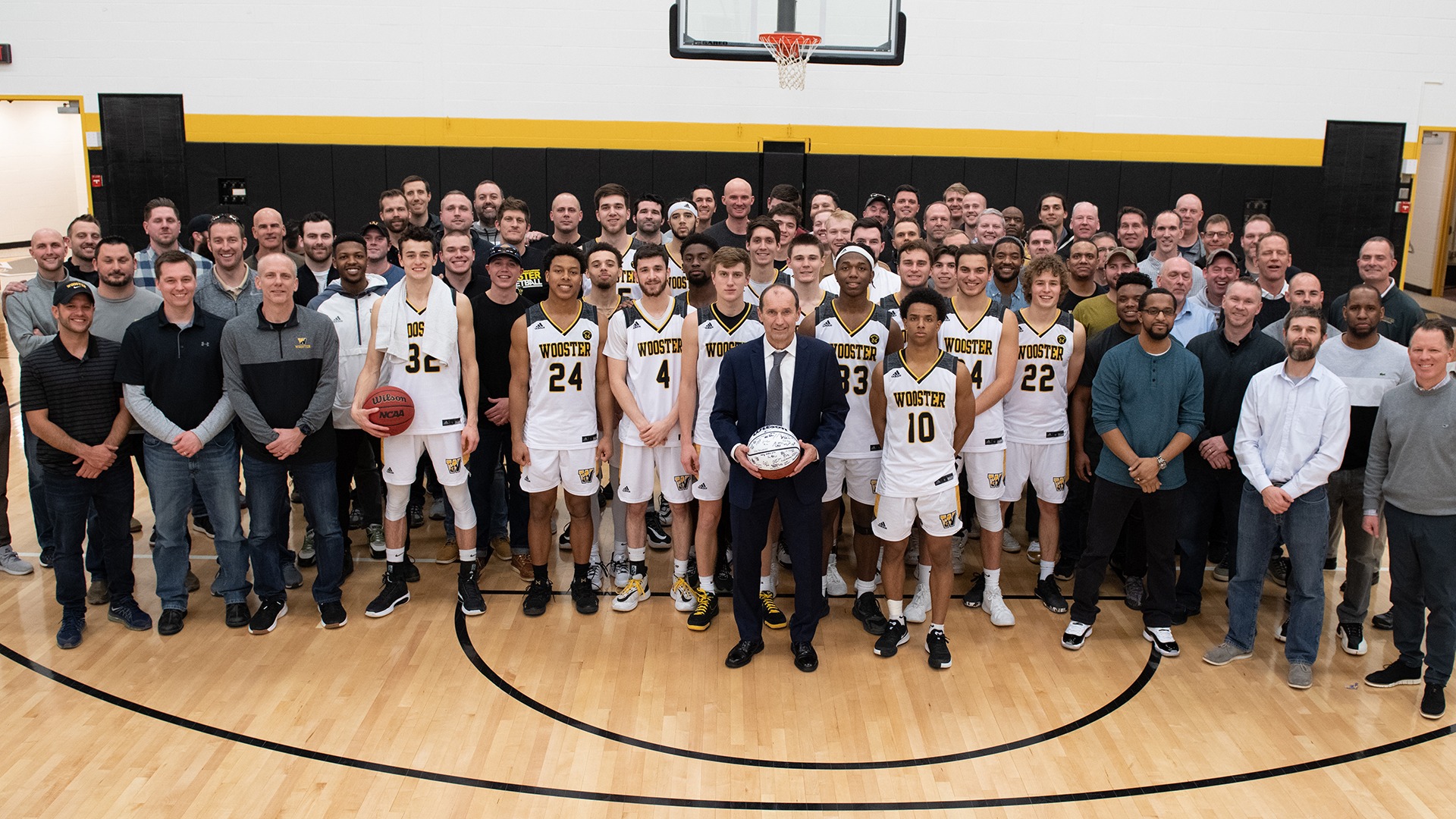 Coach Moore with large group of players he coached at Wooster following his final regular season game as head coach
