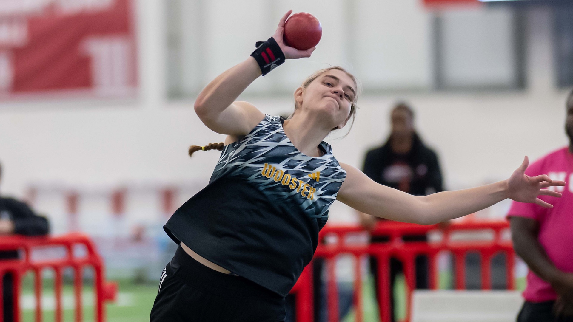 Kylie Parsons throws the shot put in an indoor meet