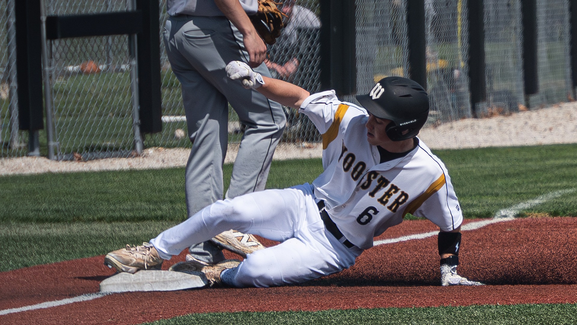 Bennett Grossman slides into third during a 2026 game against DePauw.