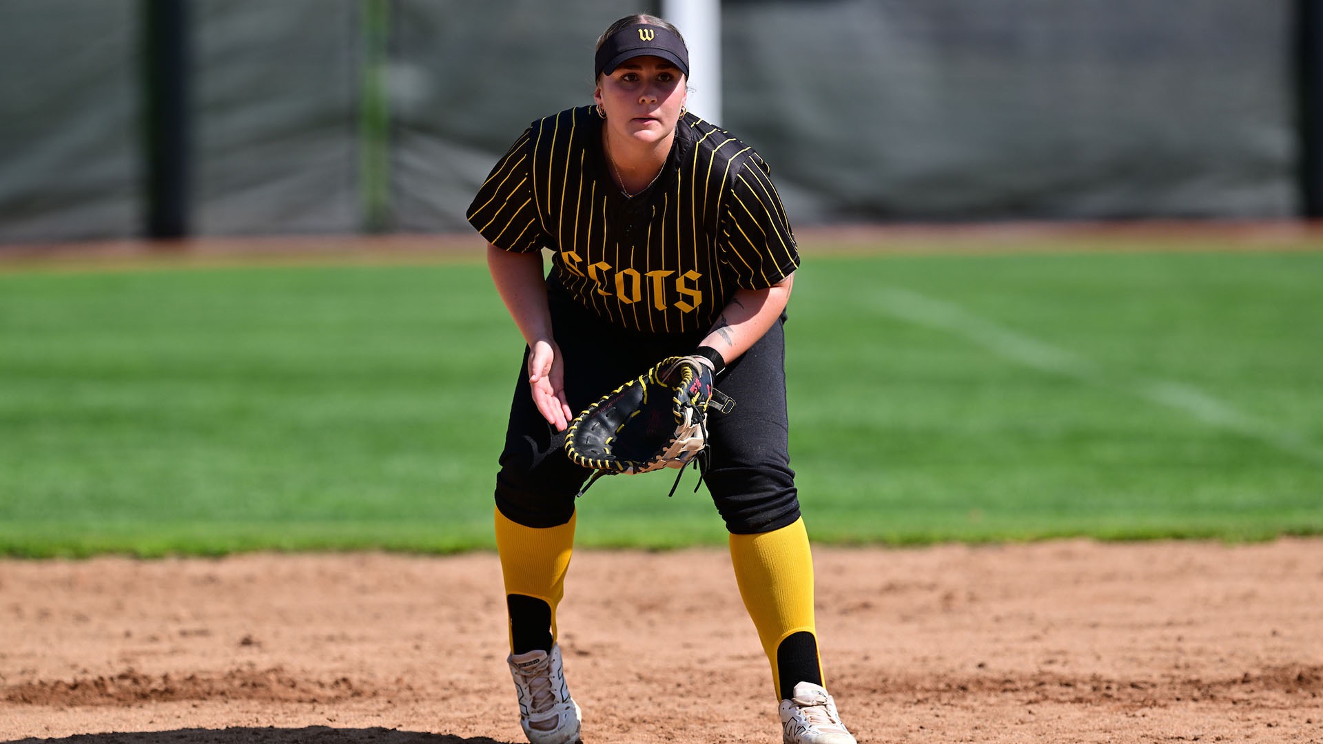 Addie Nichols prepare for the pitch at first base