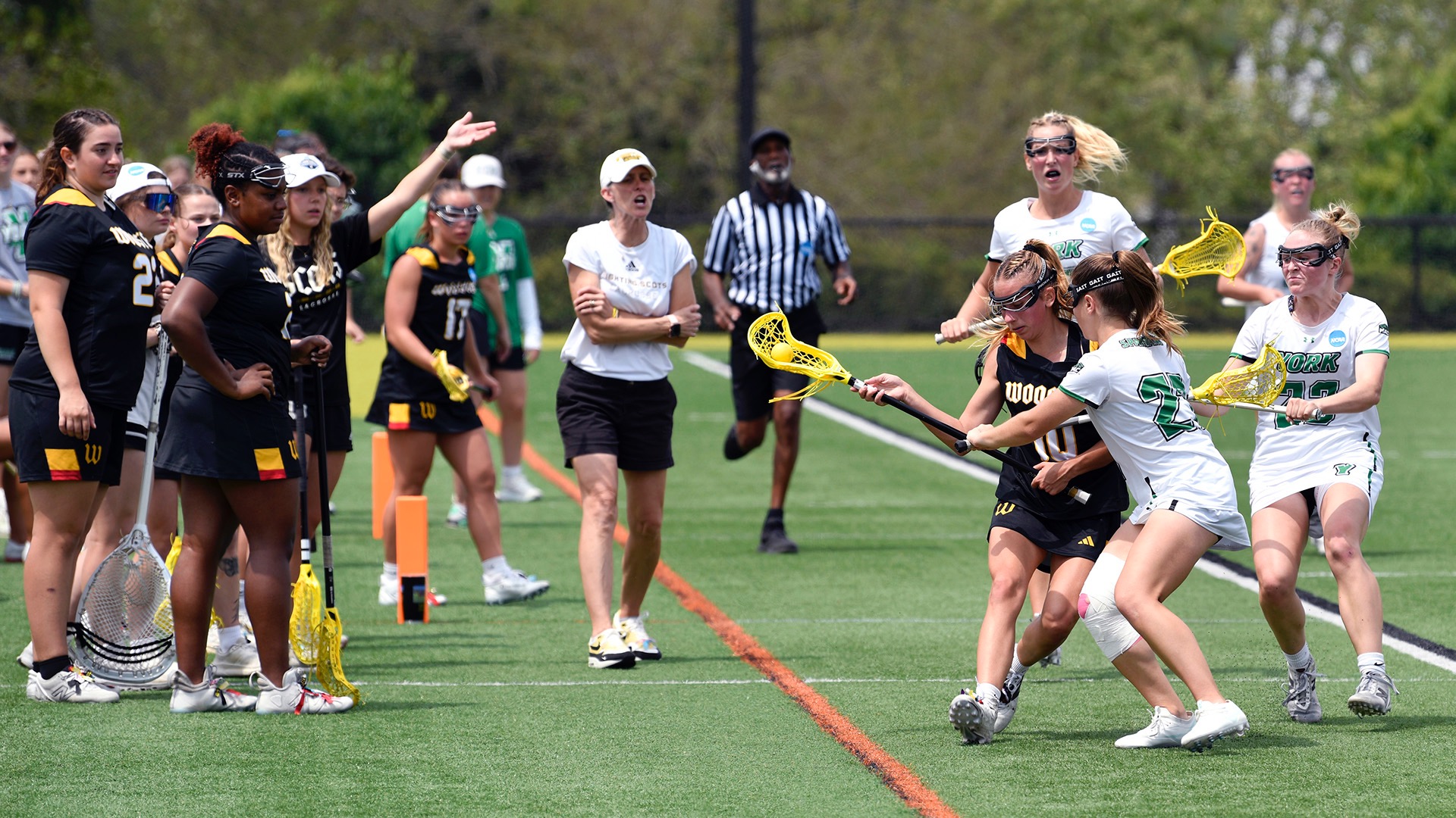 Lizzie Hardy runs down the sideline facing York pressure with the Wooster sideline cheering her on