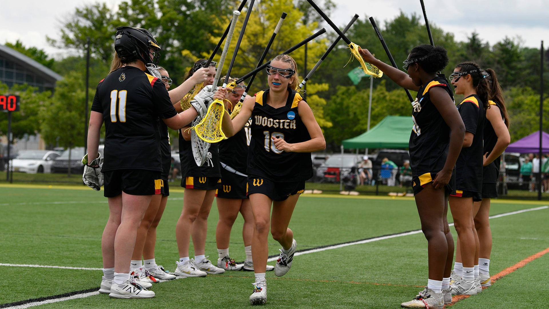 Lizzie Hardy runs through a tunnel of teammates during introductions of the NCAA Div. III Championship second-round game at York