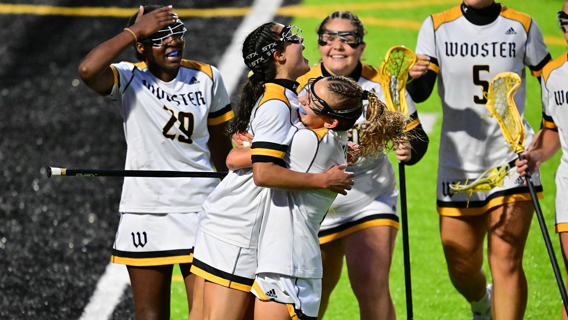 Wooster women's lacrosse players celebrate winning the NCAC Tournament semifinal game against Kenyon in 2026.