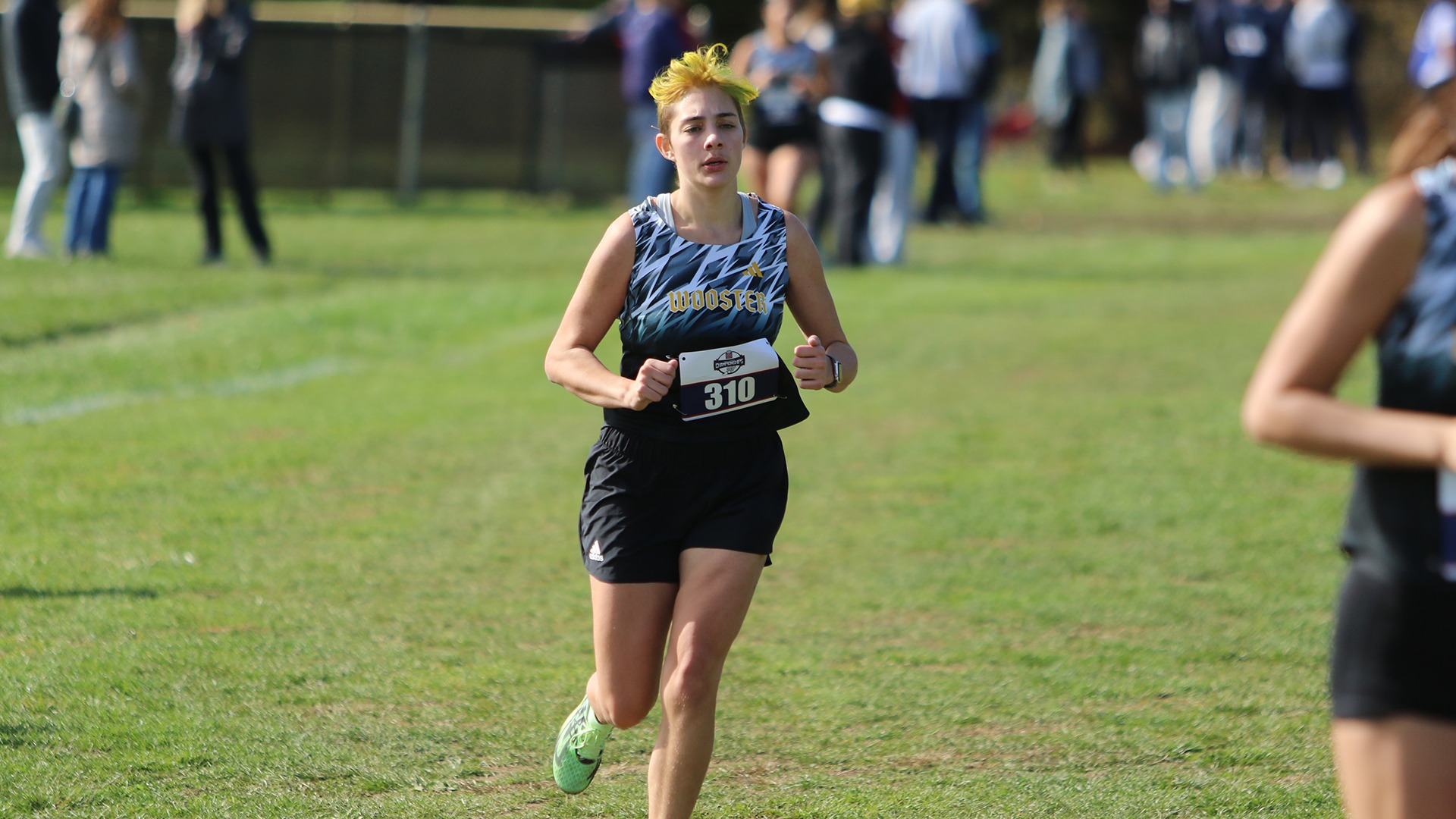 Photo of Wyn Caudle running at the 2025 NCAC Championships