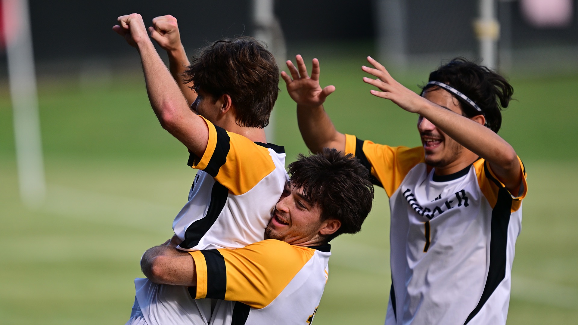 Connor Shea, embraced by Evan Peratopoulos with Aris Christodoulou celebrating to the right