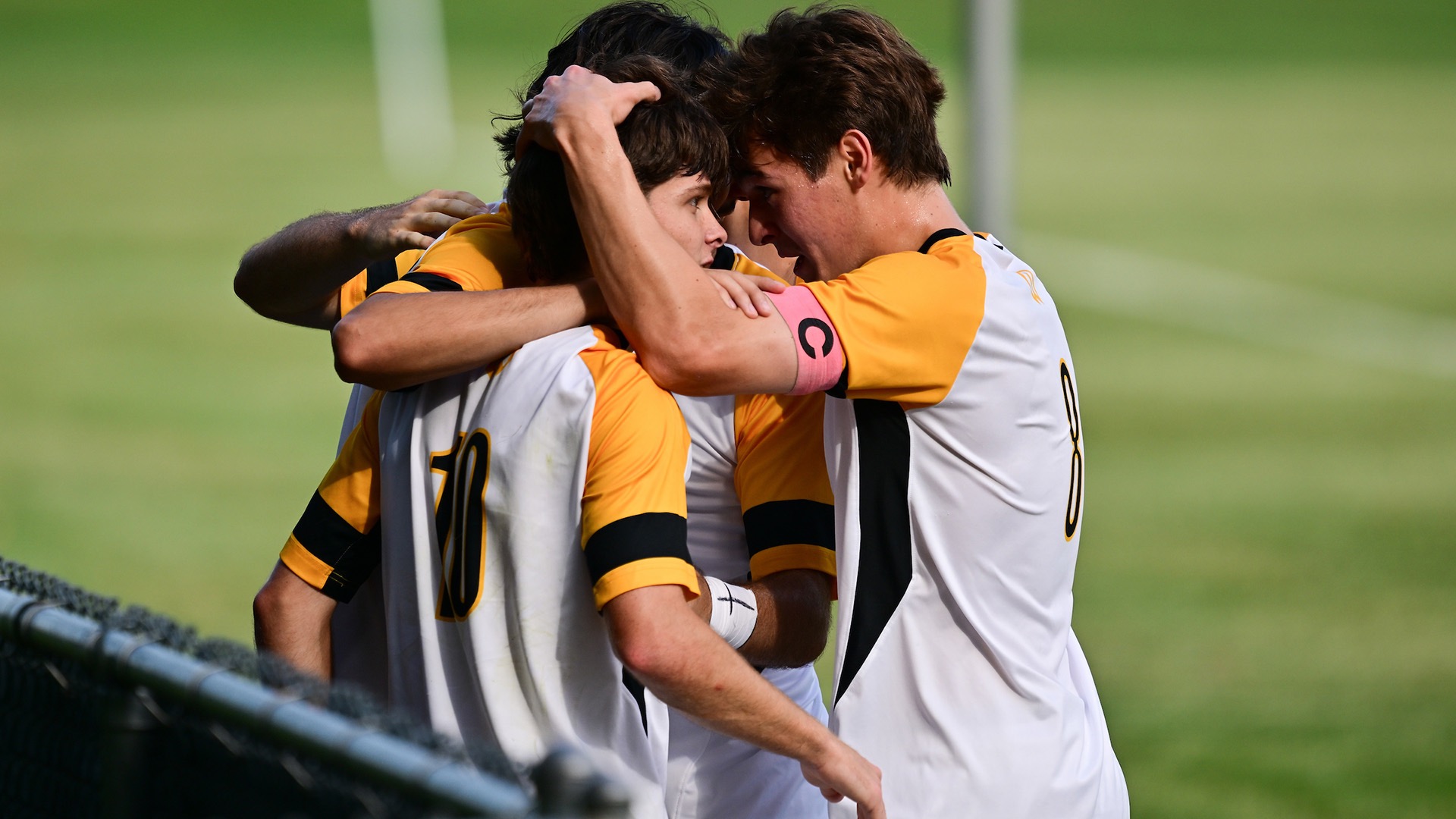 Three players huddle following a score
