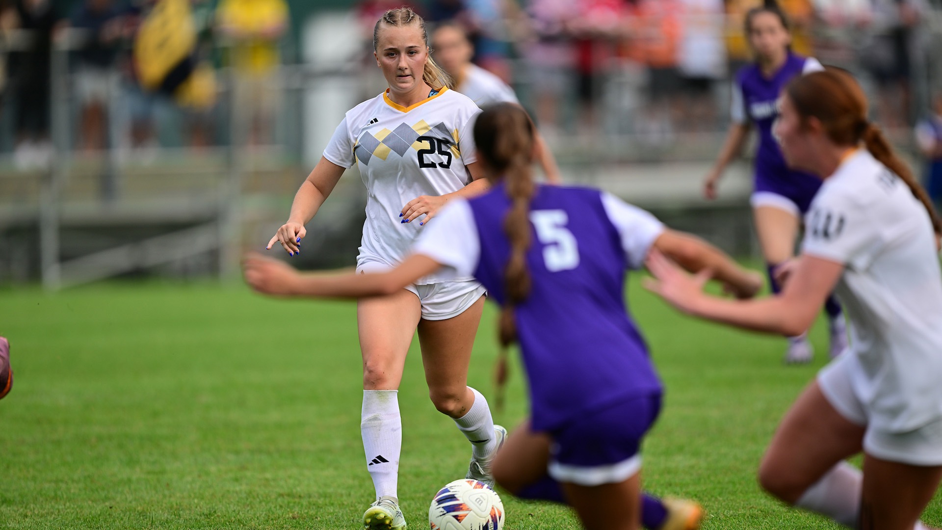 Annie Henegar looks upfield with a Mount Union defender in the foreground