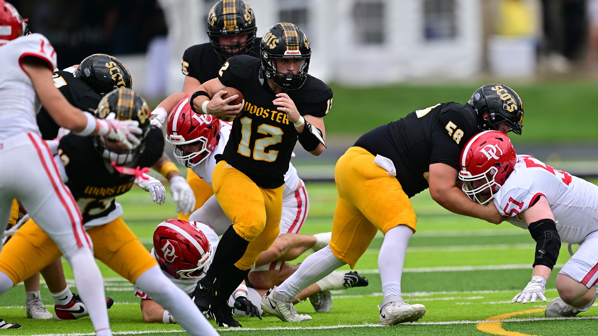 action photo of Mason Delmarle running with the football against Denison