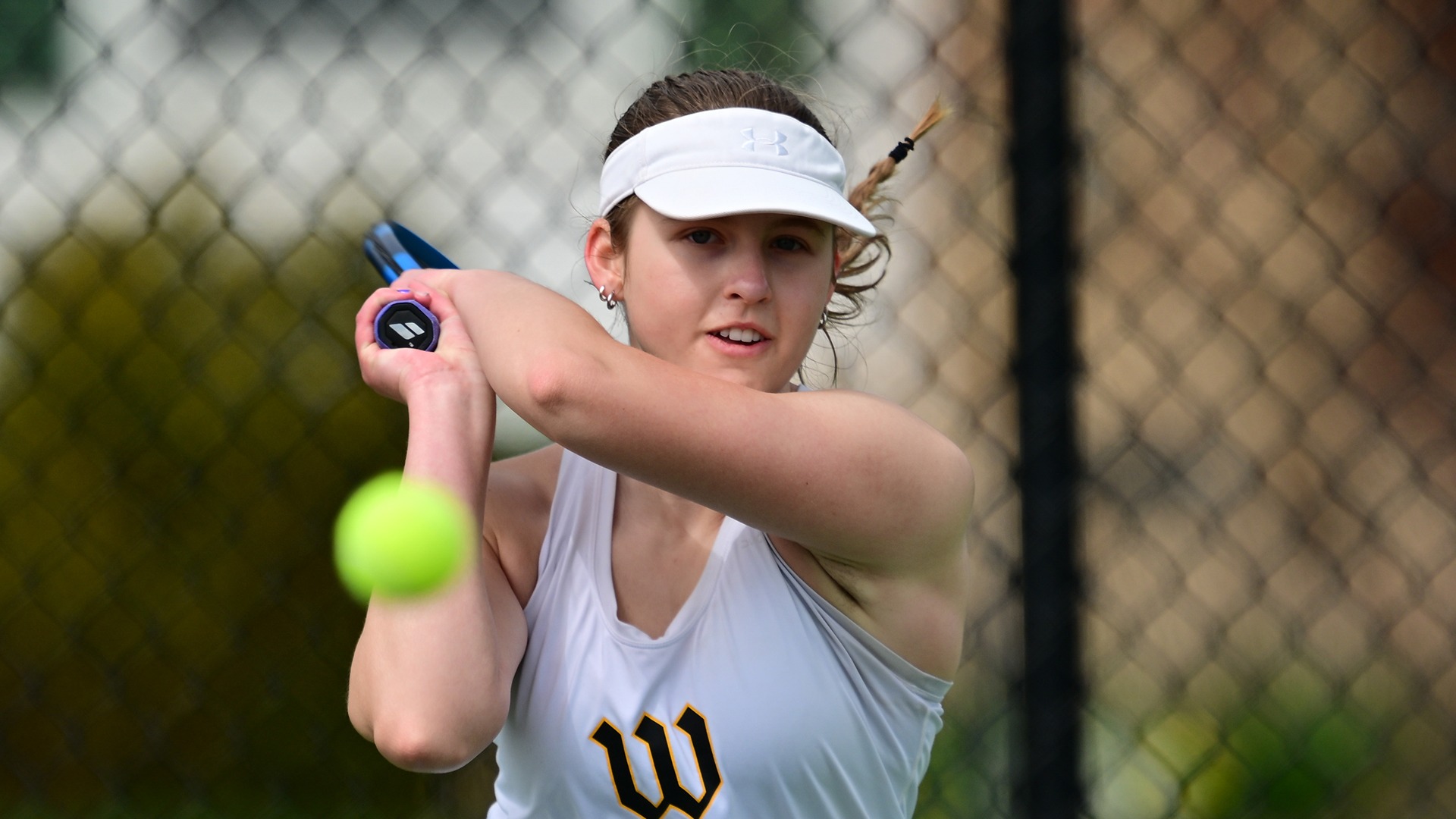 Action photo of Sasha Riley hitting the tennis ball
