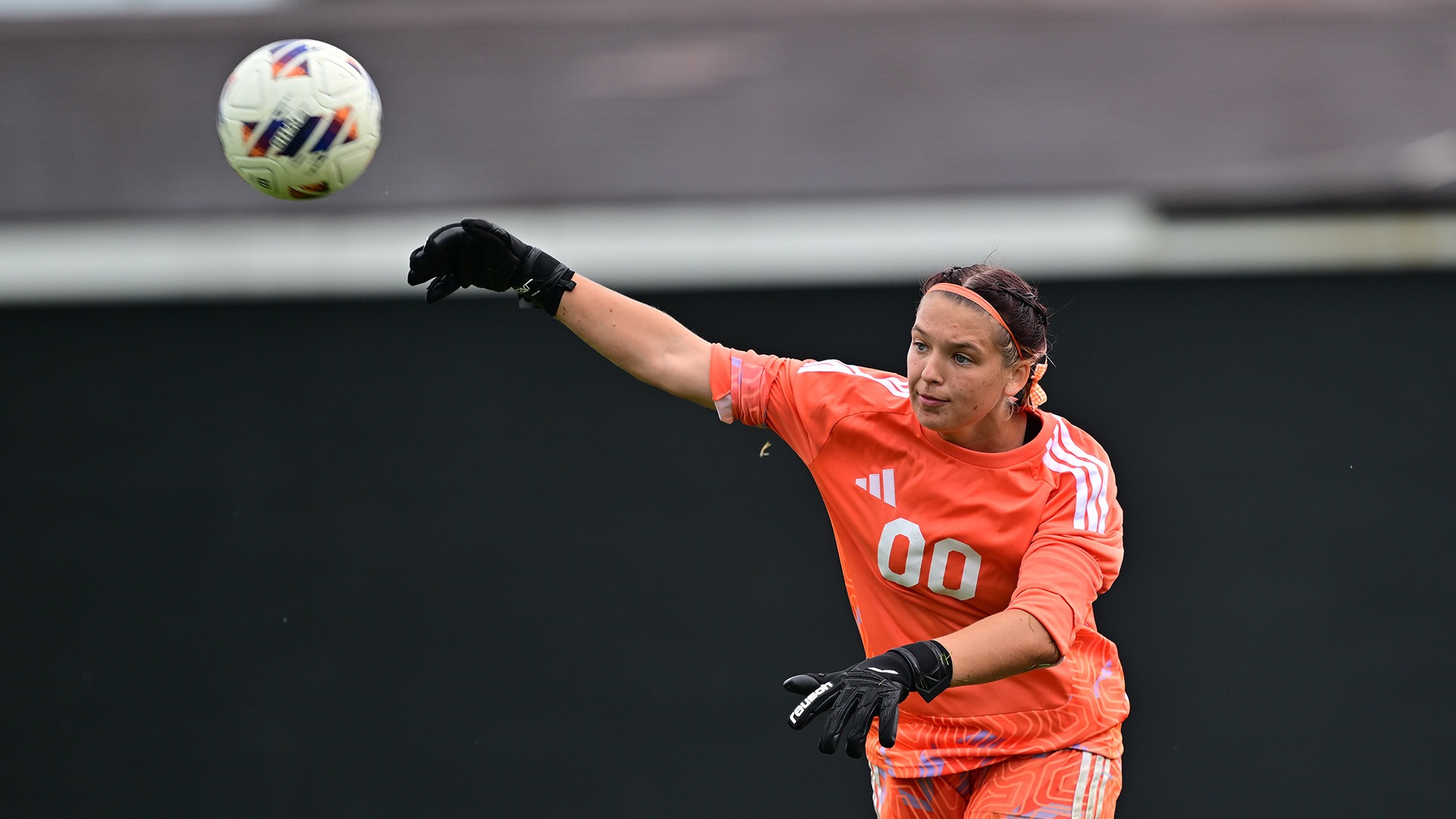 Lucy Carlin throws a soccer ball