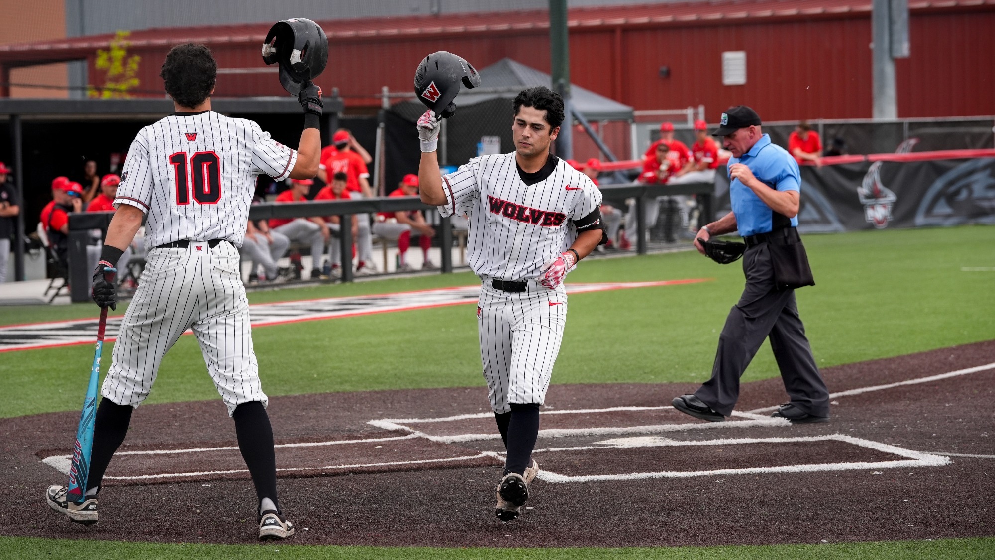 Chris Arce is congratulated at home plate after a home run Friday against Northwest Nazarene in Nampa, Idaho.