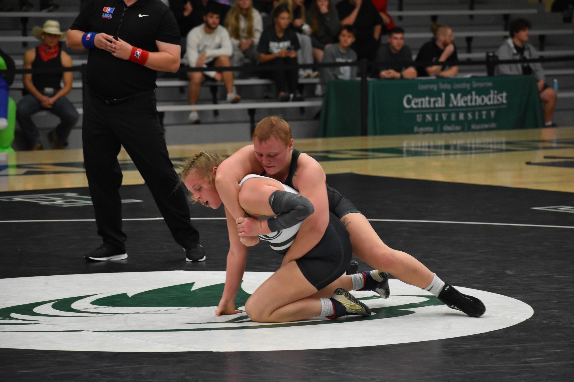 William Woods' Abby Piper grapples with a Central Methodist wrestler.