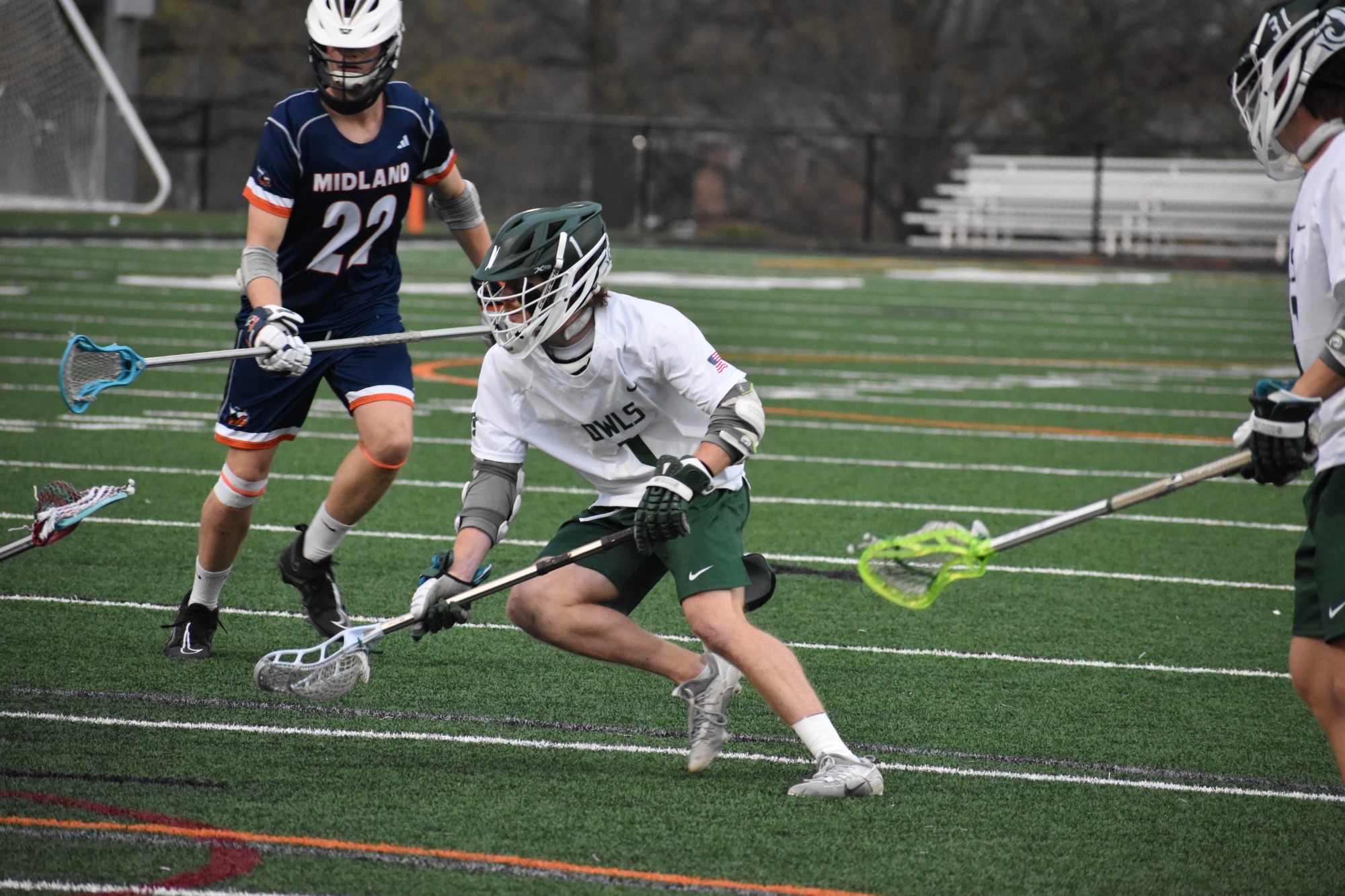 William Woods's Sam Snyder runs with the ball in his stick.