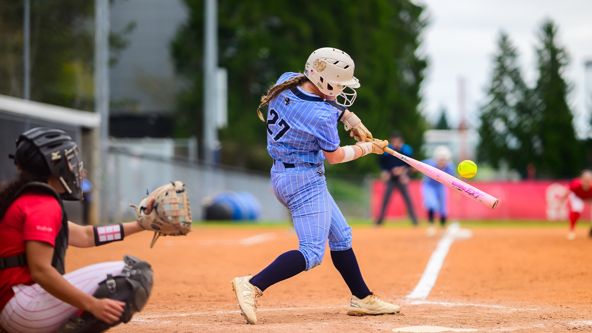 WWU Softball Player Swinging a bat on a softball field