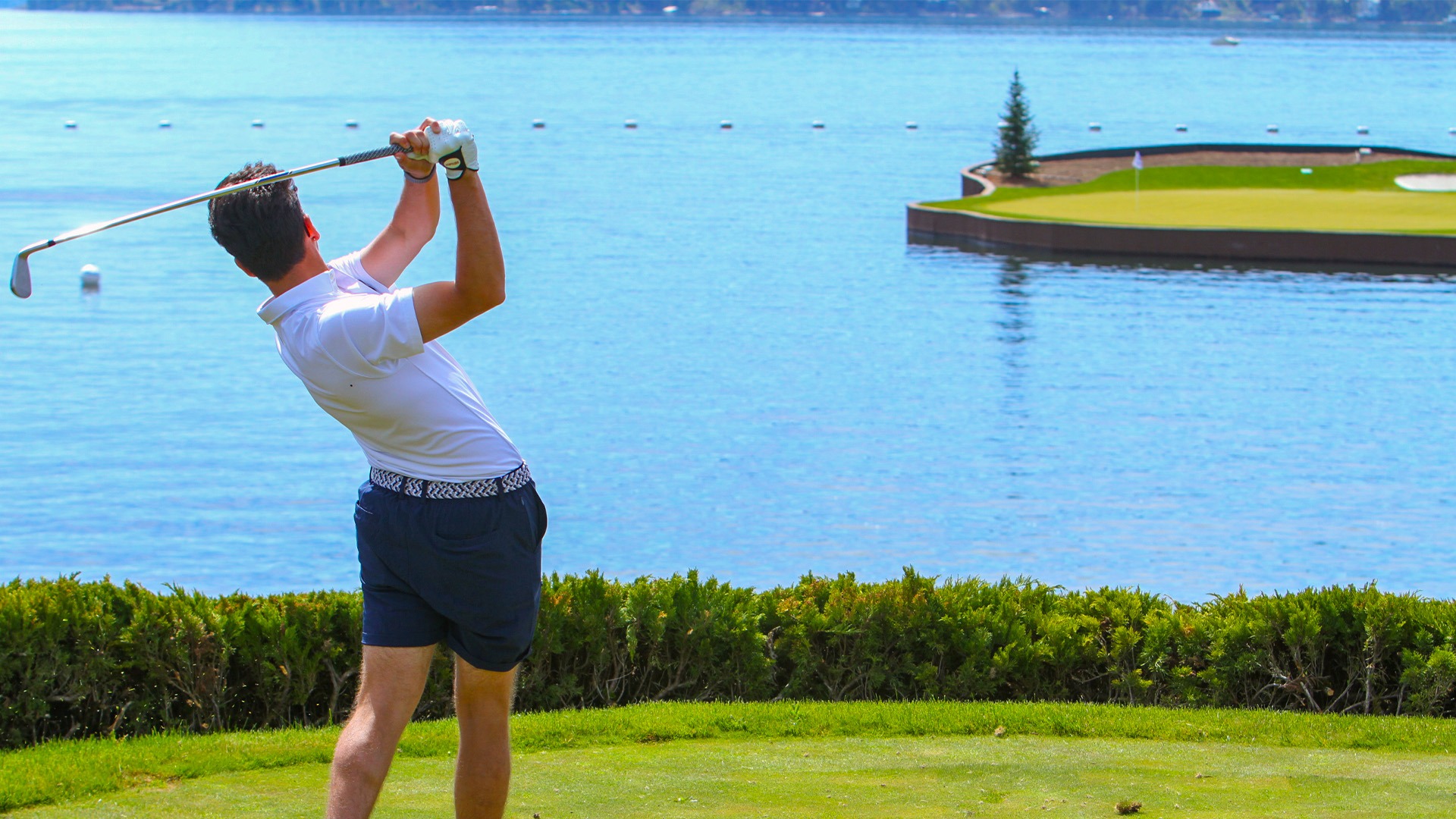 Christopher Zamani at GNAC Championships - Golfer taking a swing at a hole that features a floating green